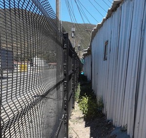 Photo of fence and shacks