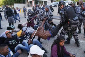 Photo of protesters and private security