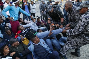 Photo of protesters and private security