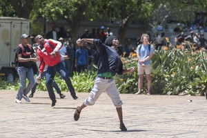 Photo of man throwing stone