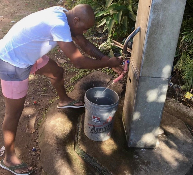 Photo of a man at a tap