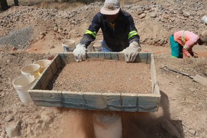 Photo of men in a mining trench