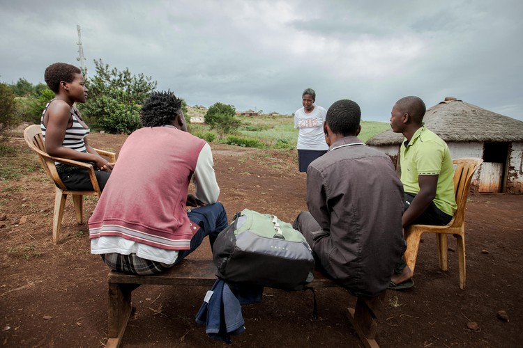 Photo of group of people listening to HIV talk