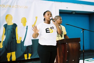 Photo of woman speaking on a mic