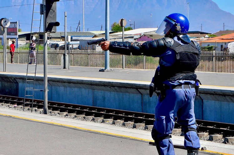 Photo of a policeman with a handgun drawn