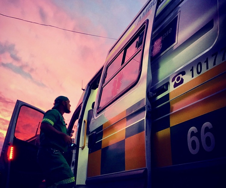 Photo of man climbing into an ambulance