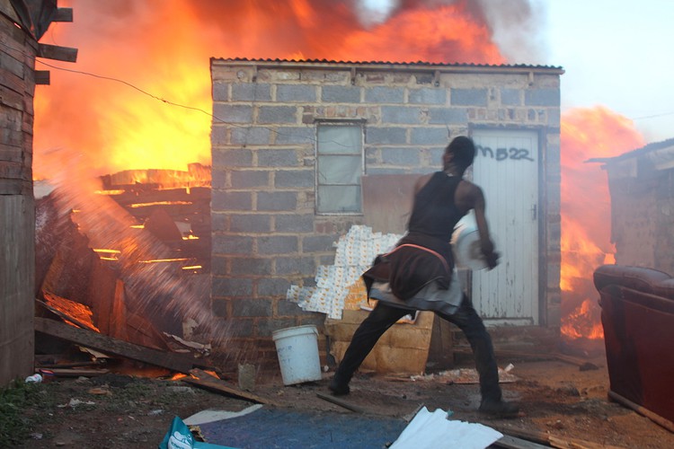 Photo of man putting out fire