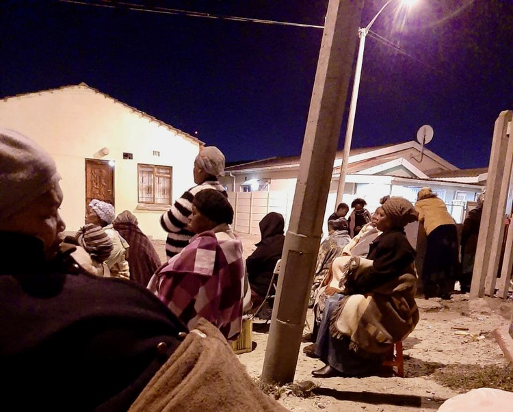 Photo of a group of women in a street at night