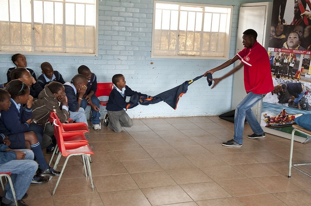 Photo of man and children in classroom