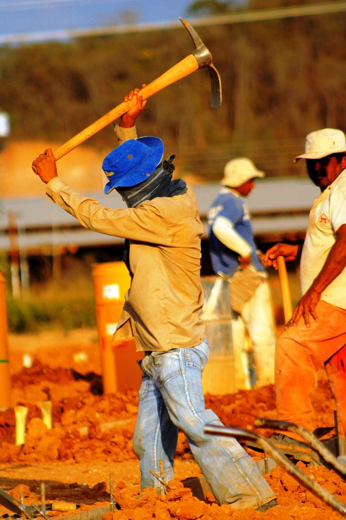 Photo of a man with a pickaxe.