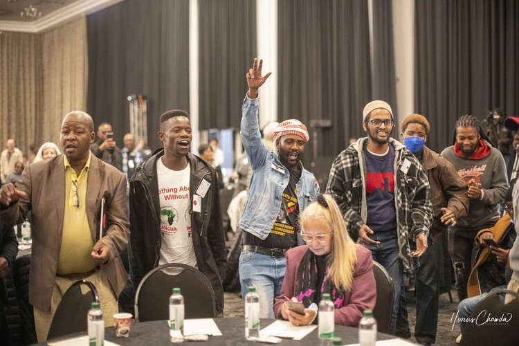 Photo of people singing at Defend Our Democracy conference