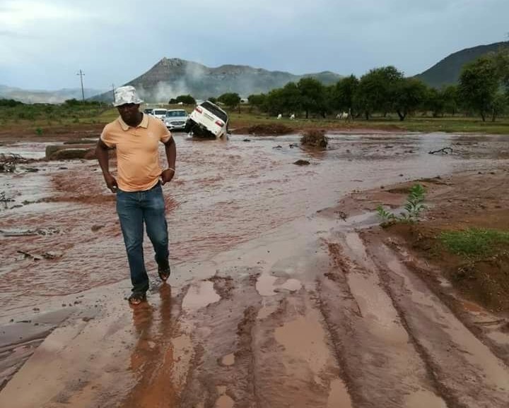 Photo of car stuck in donga or mud