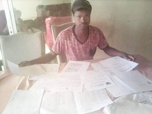 Photo of man surrounded by papers