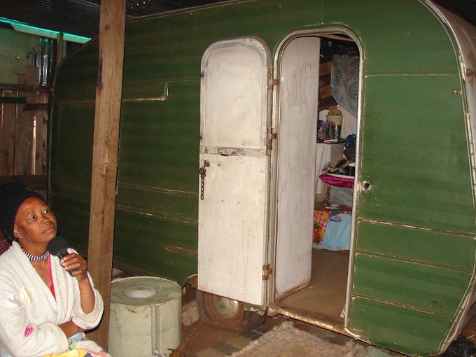 Photo of woman in front of a caravan