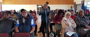 Photo of man speaking in meeting