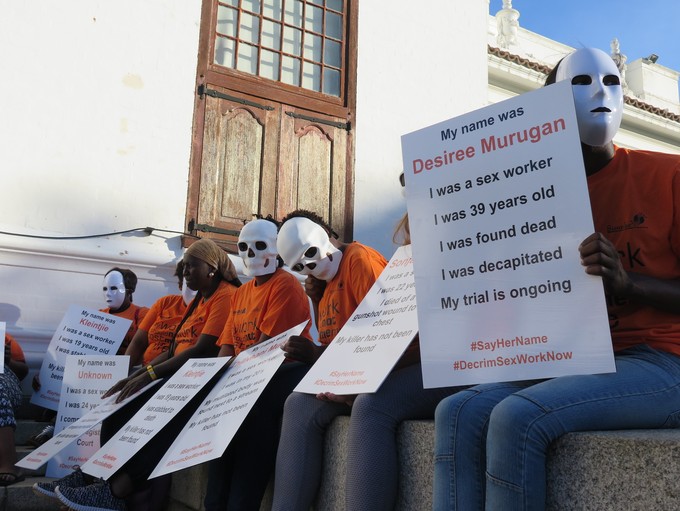 Photo of protesters in white masks 