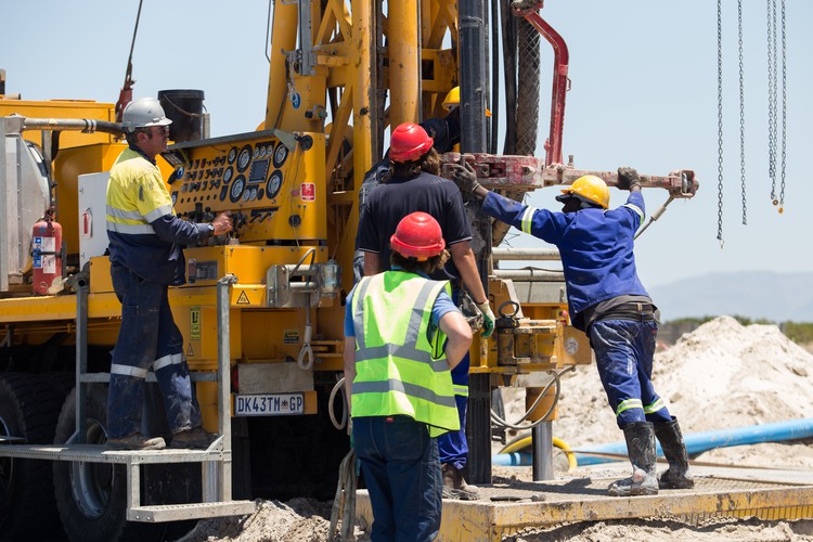 Photo of people drilling for water