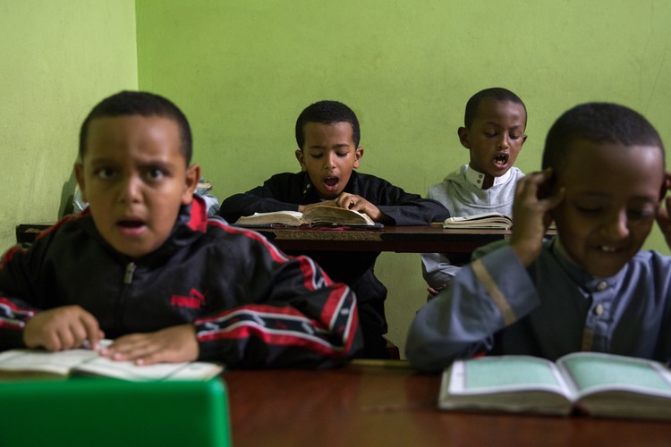 Photo of children studying Quran