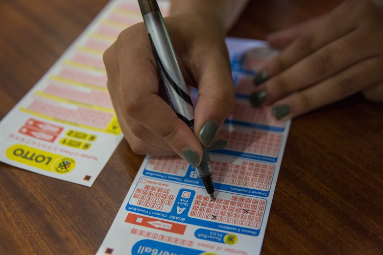 Photo of hand filling in Lottery ticket