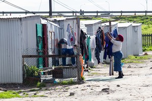 Photo of a woman hanging up laundry