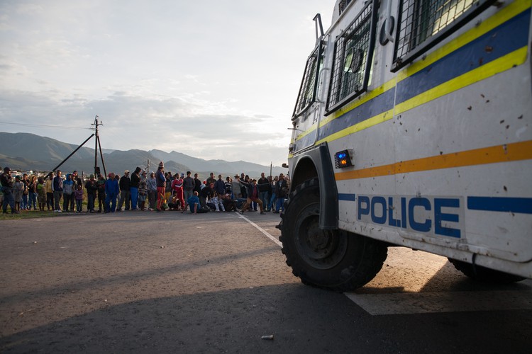 Photo of a police vehicle in front of a protest