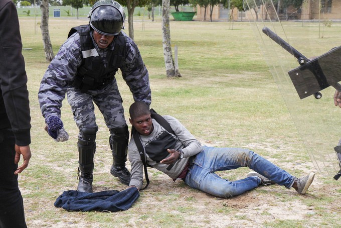 Photo of security guard dragging student