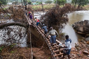 Photo of people crossing bridge