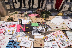 Photo of wreaths and placards in front of Parliament