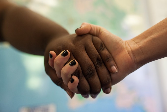 Photo of two women holding hands