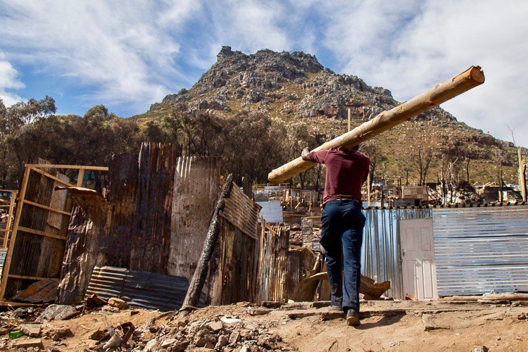 Photo of a man walking with a pole