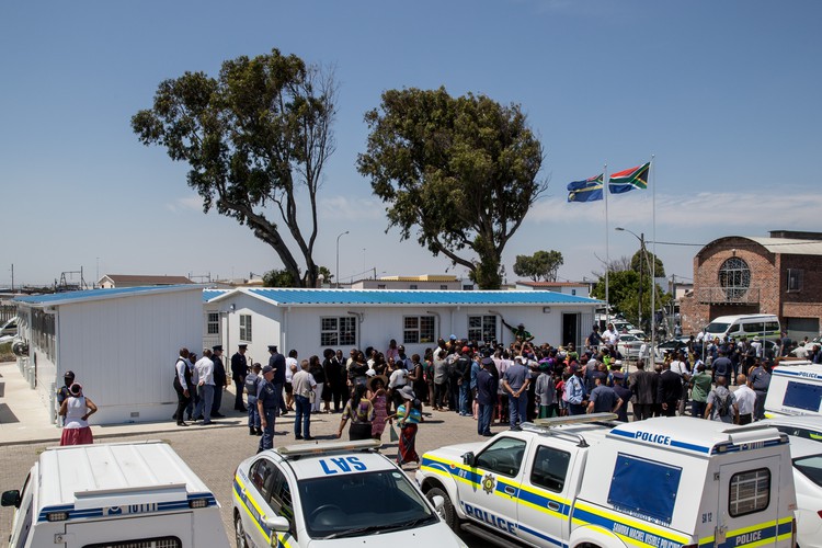 Photo of crowd with police cars