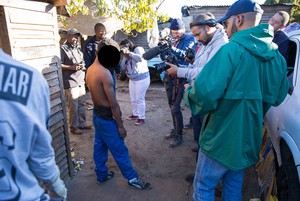 Photo of man surrounded by journalists