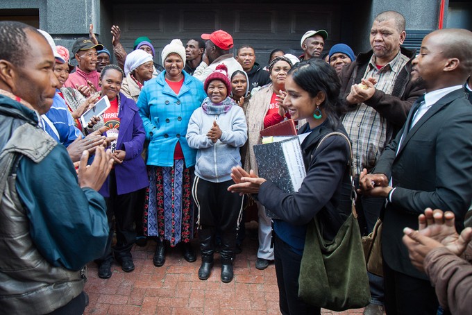 Photo of applauding workers outside court