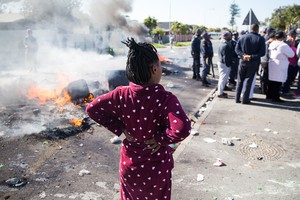 Photo of person watching burning barricade