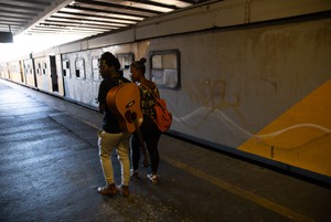 Photo of people walking next to a train