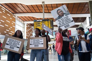 Photo of picketers at the train station