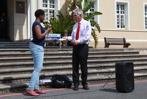 Photo of Kanyisa Ntombini handing over a memorandum to Max Price.