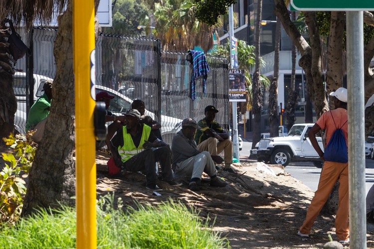 Photo of men waiting on roadside for work