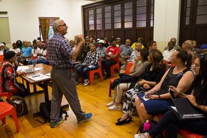 Photo of man addressing meeting