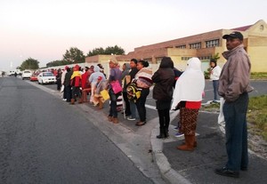 Photo of people standing in a queue