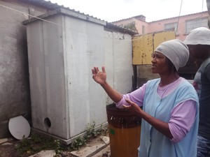 Photo of a woman outside a toilet