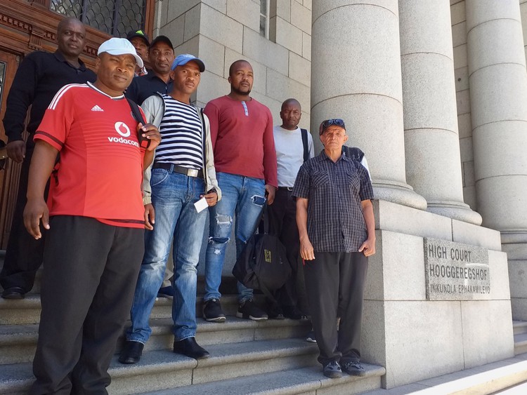 Photo of people on the steps of the court