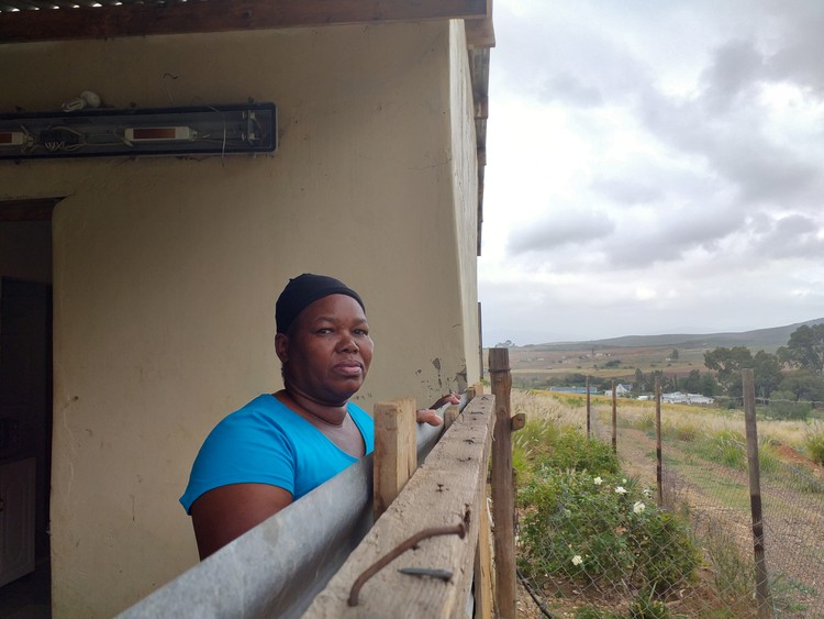 Photo of woman next to house