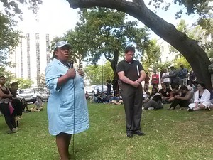 Photo of worker addressing meeting.