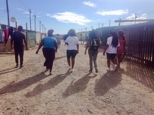 Photo of four people walking