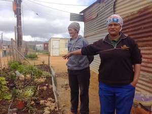 Photo of Jakoba Fredericks in front of her home.