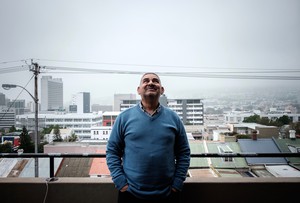 Photo of man standing in front of buildings