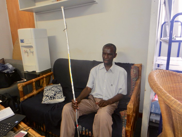 Photo of a blind man with a white stick