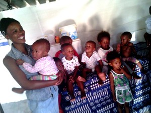 Photo of a woman with a row of  small children