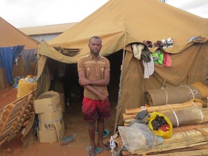 Photo of man outside tent